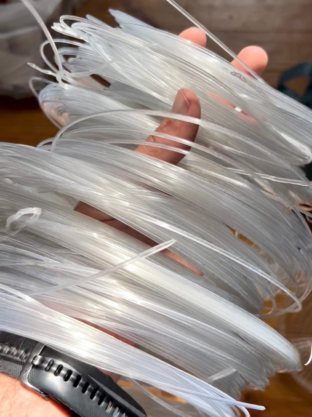 A handful of short, unjoined lengths of clear PET filament
